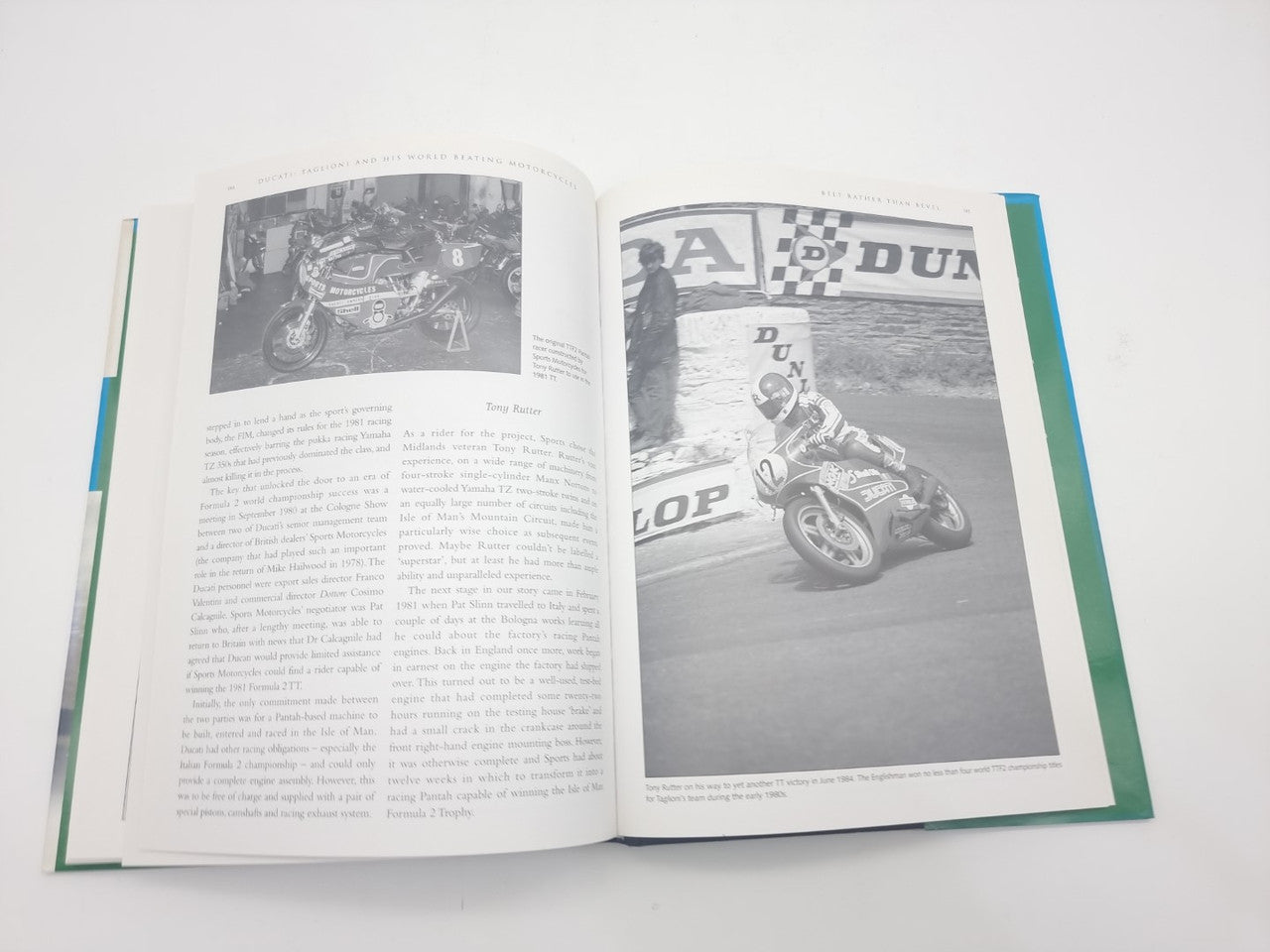 Motorcycles book opened to pages with Ducati racing photos and article text