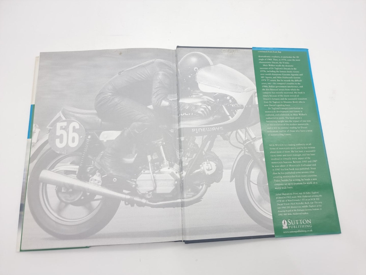 Motorcycles book opened with a large grayscale bike image and green information panel