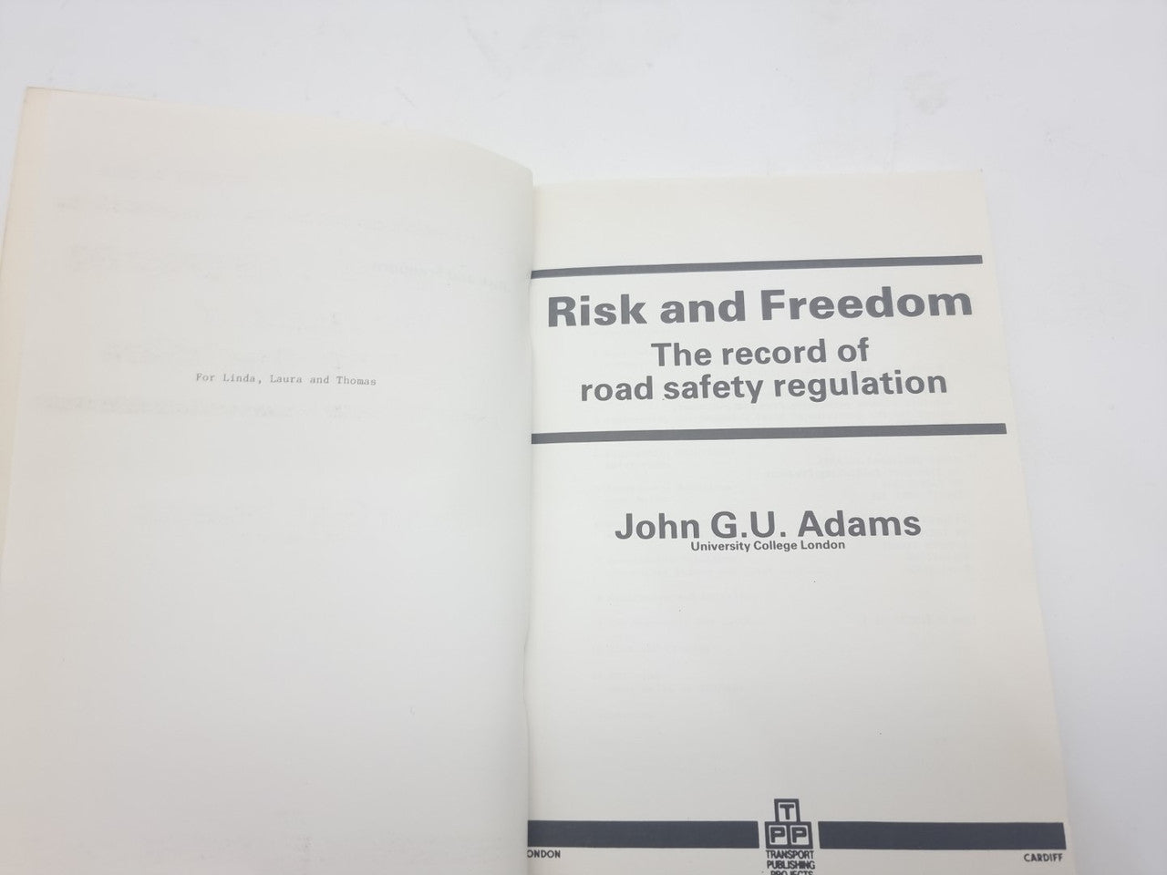 Opened book showing cover page design, title bands, and publication logos