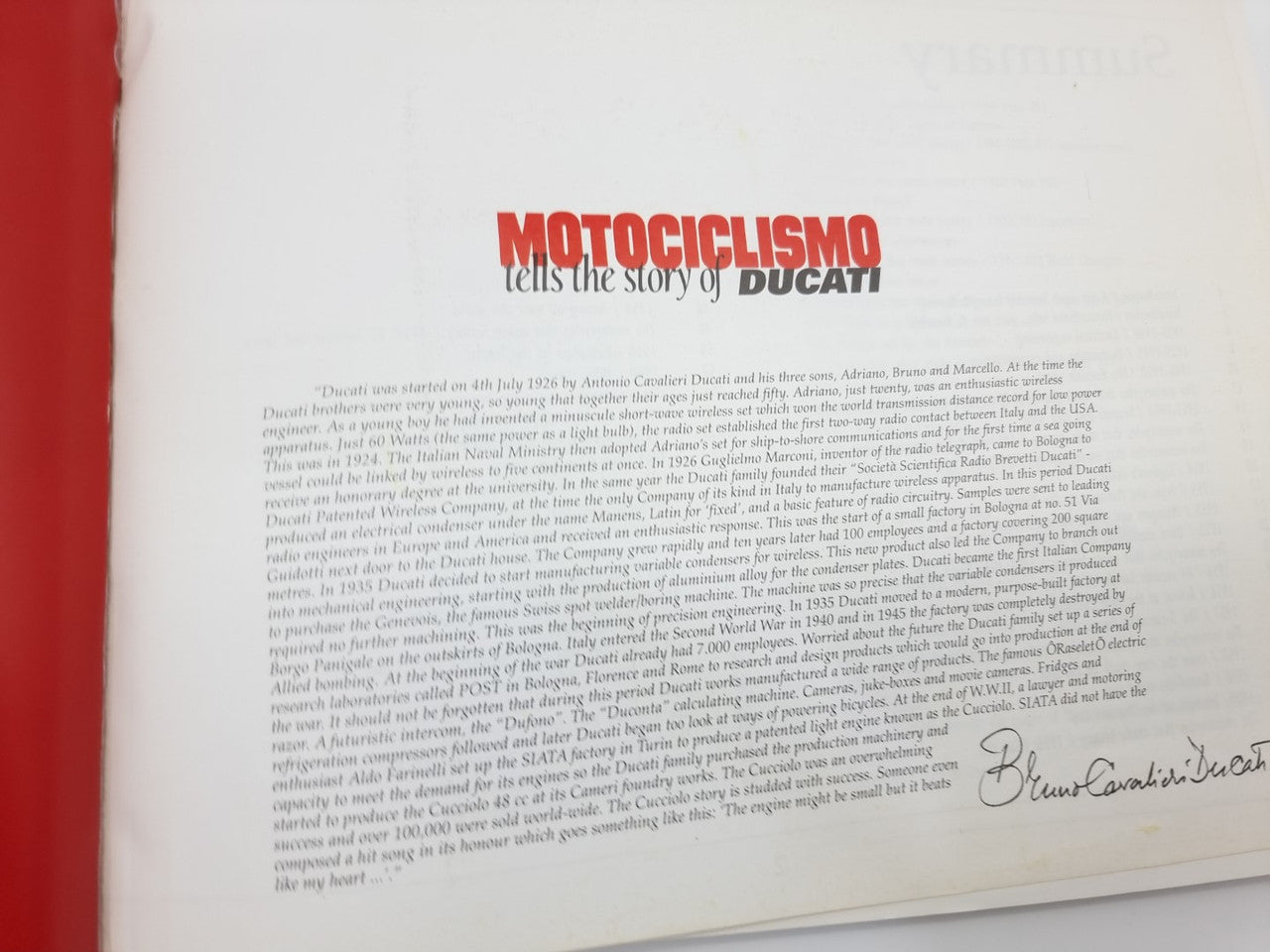 Opened book page with “Motociclismo tells the story of Ducati” heading and paragraphs