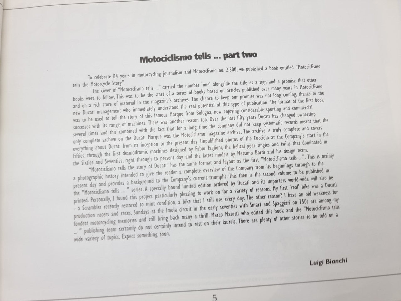 Opened book page: “Motociclismo tells … part two” with author name