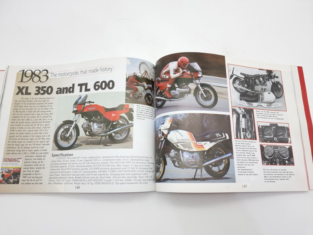 Open motorcycle history book spread with red-and-black sport motorcycle and specifications