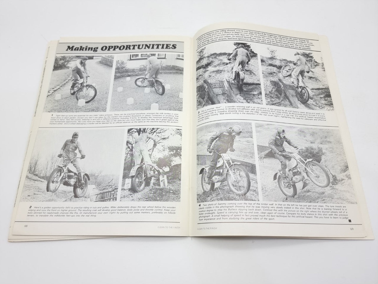 Open motorcycle trials book spread with action photos and instructional text