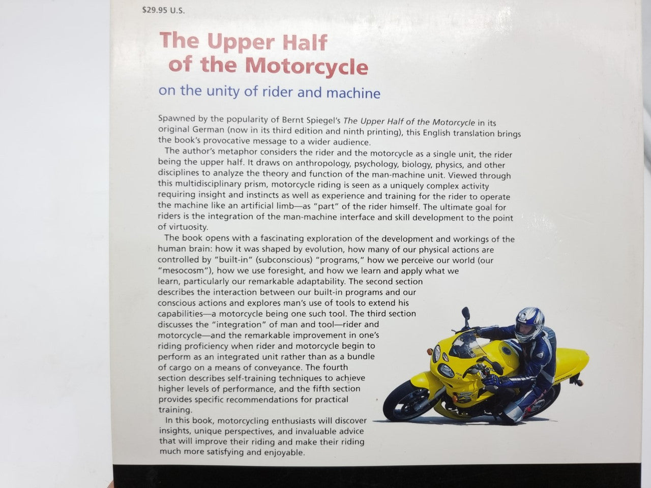 Hardcover book front cover with red title text and yellow motorcycle photo