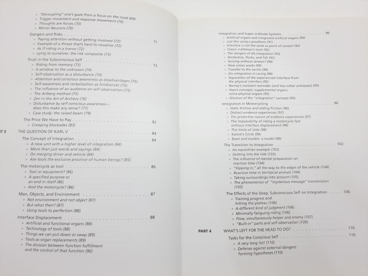 Open book chapter pages with dense text and section headings, two-page spread