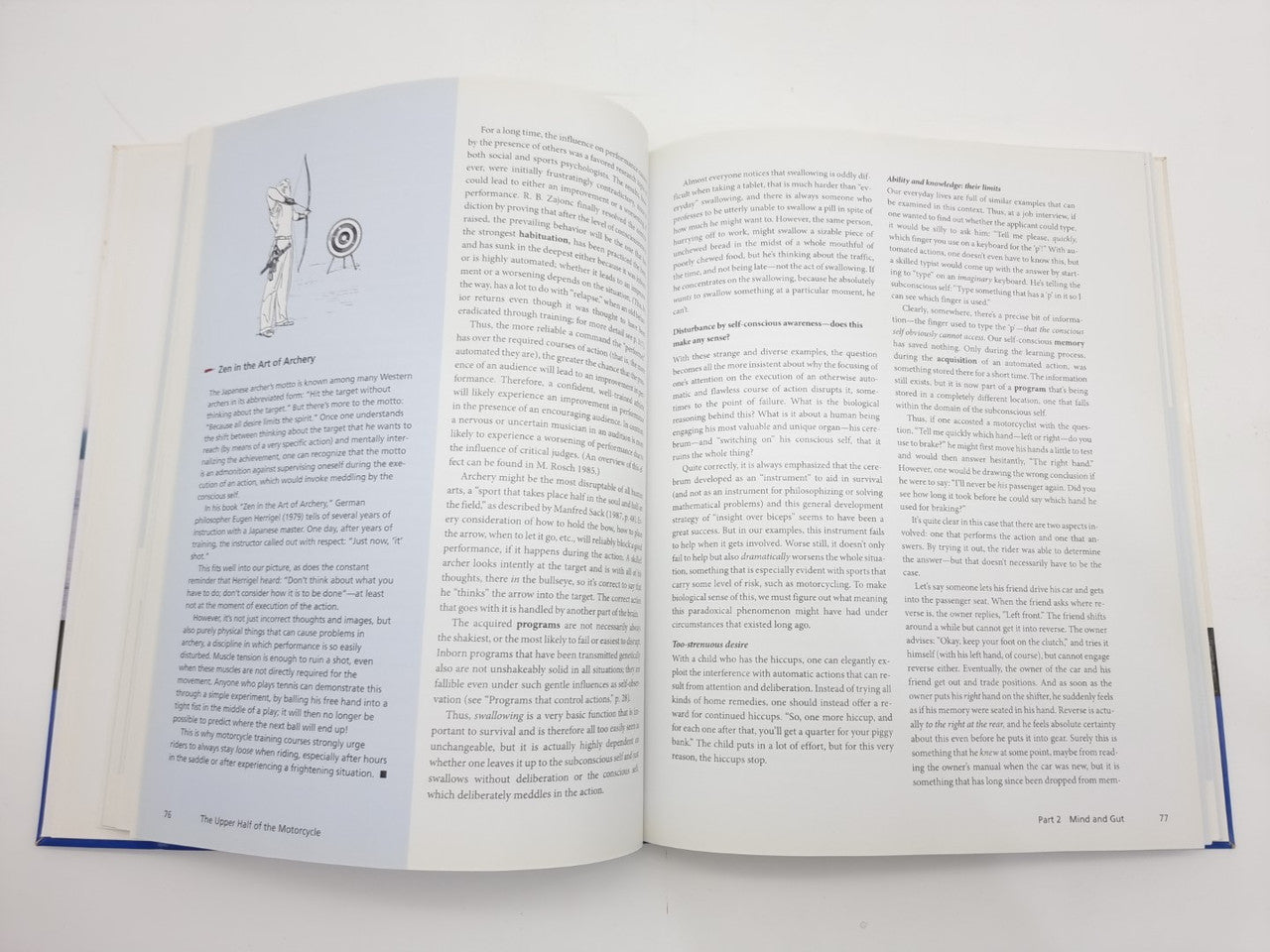 Open book with printed text and small line diagram on left page, blue page edge