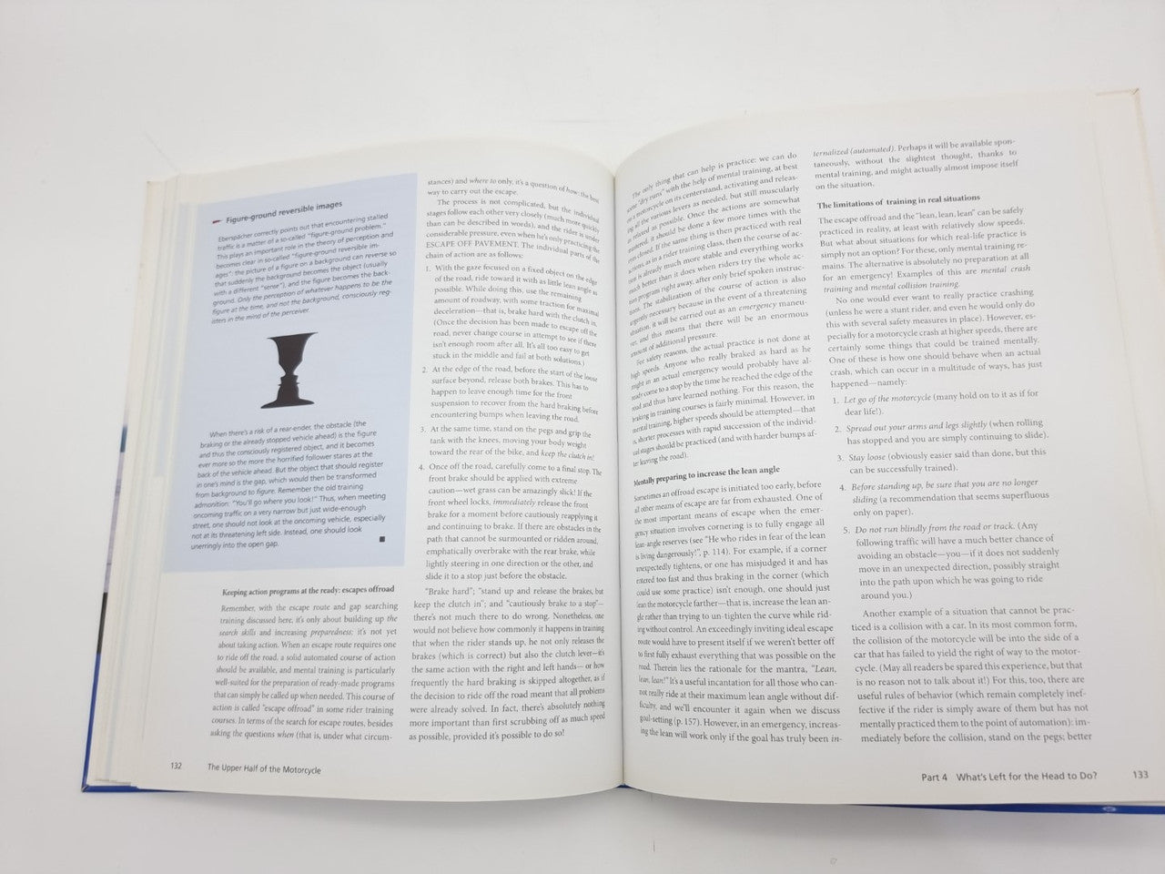 Open book spread with a large drop-cap illustration on left and dense text paragraphs