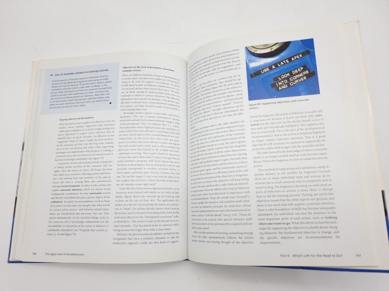 Open book spread with a blue header graphic panel on the right page text