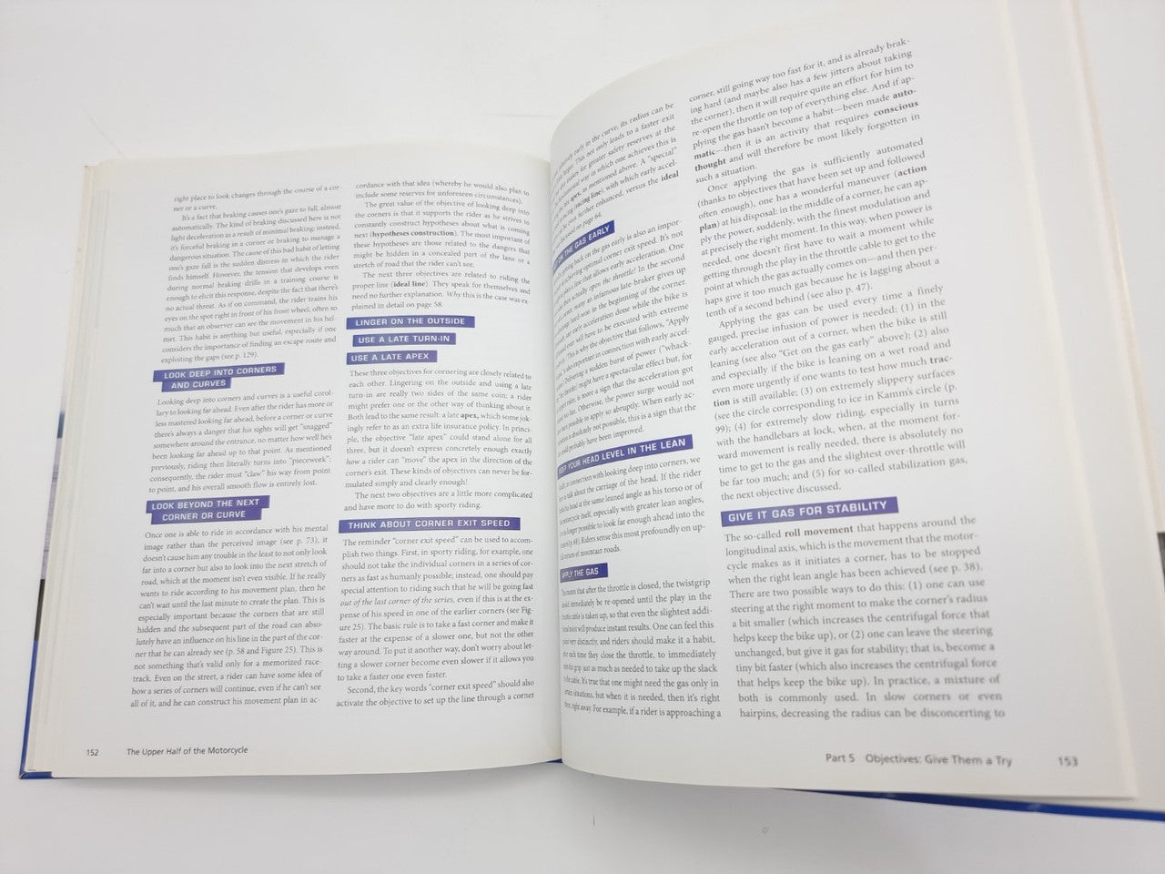 Open book spread with multiple blue section boxes highlighting text on both pages