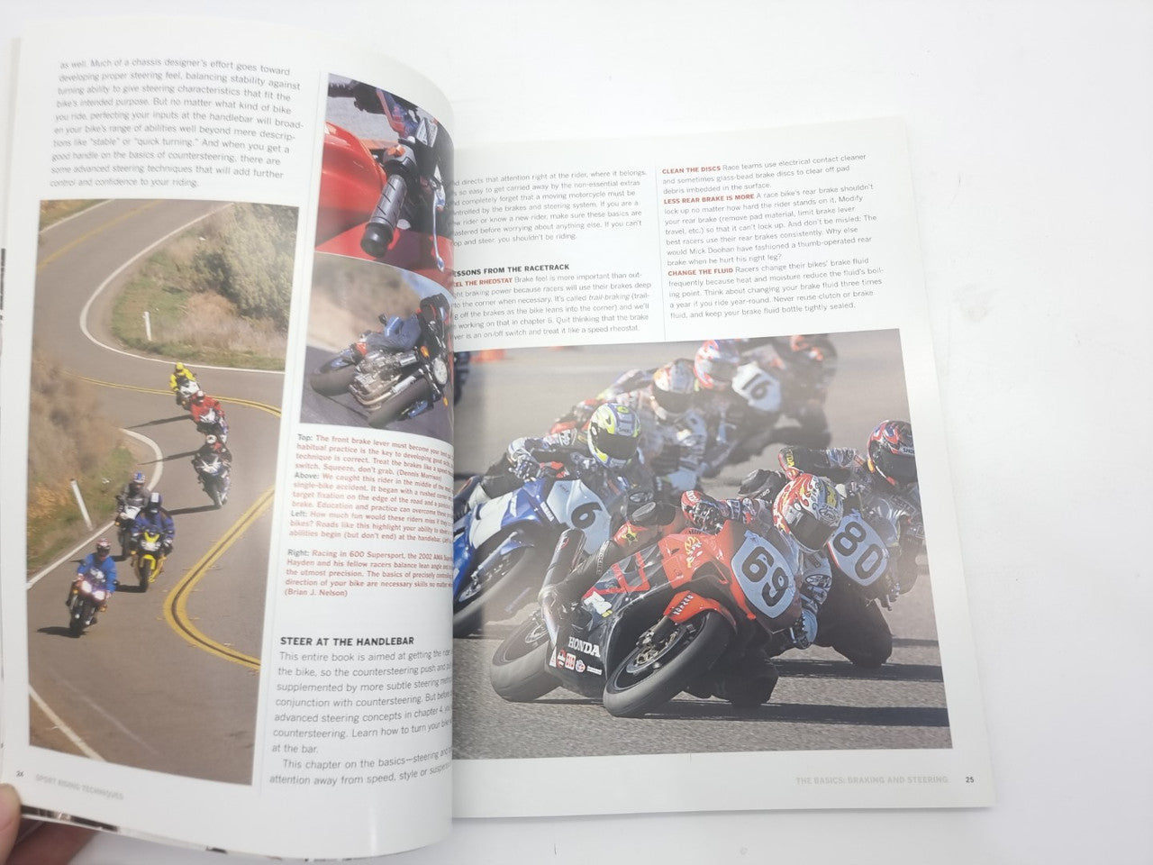 Open book spread with action photos, paragraphs of text, and layout guides