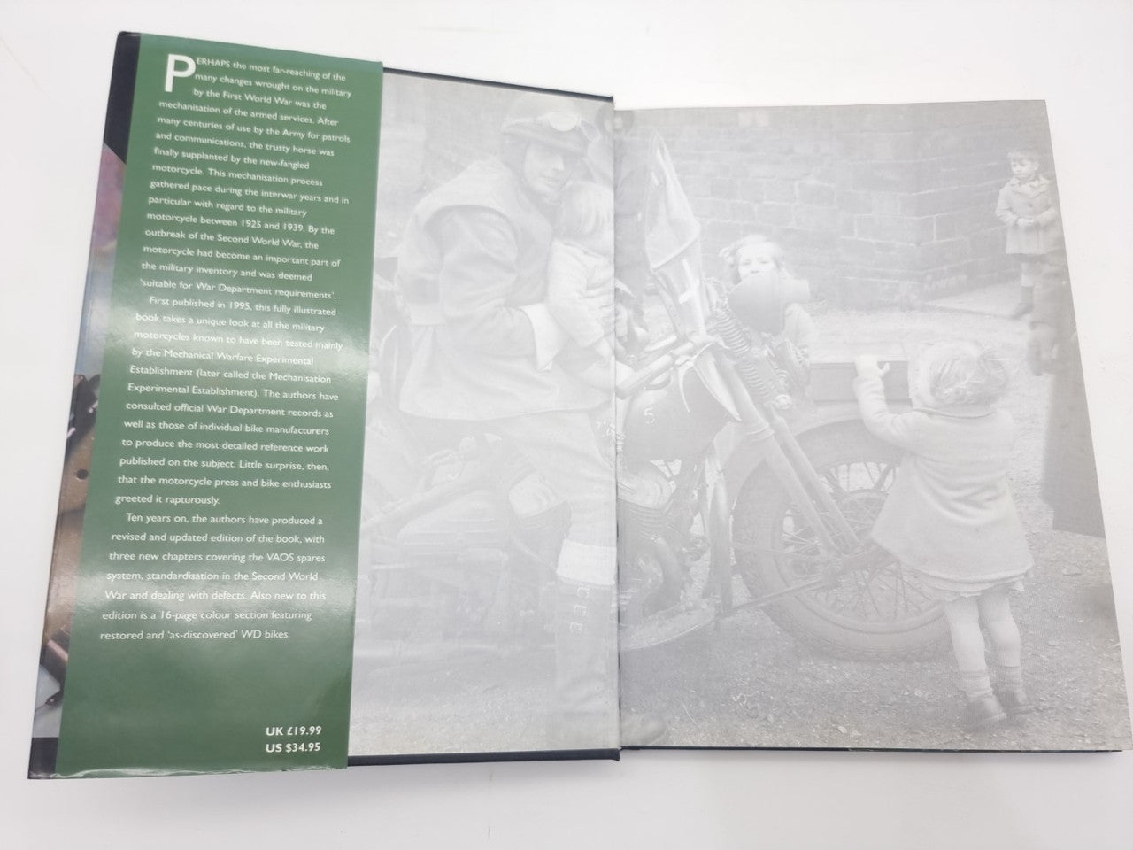 Motorcycles history book open, left green text panel and grayscale motorcycle photos