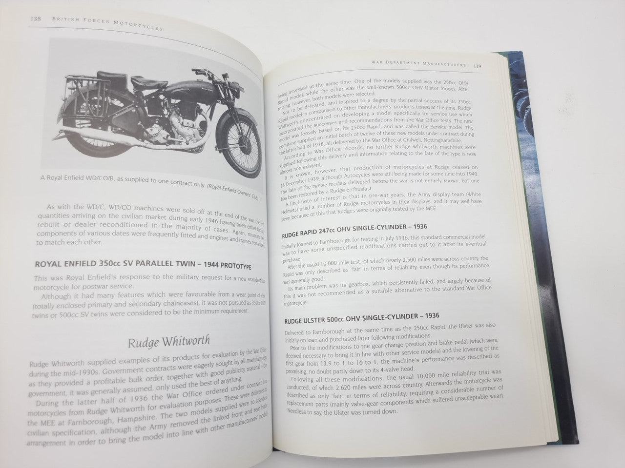 Motorcycles history book open, left page photo of classic motorcycle and text columns
