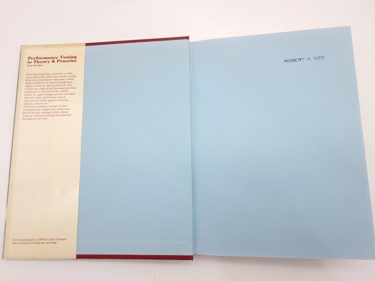 Open book showing foreword pages with red-edged binding and printed author name