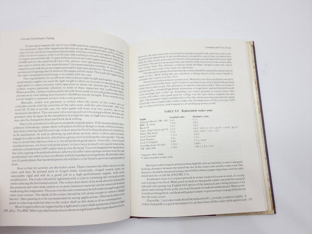 Open technical book with dense text columns and an example data table on right page