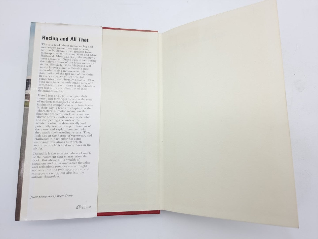 Open motorsport book with printed page on the left and blank right page