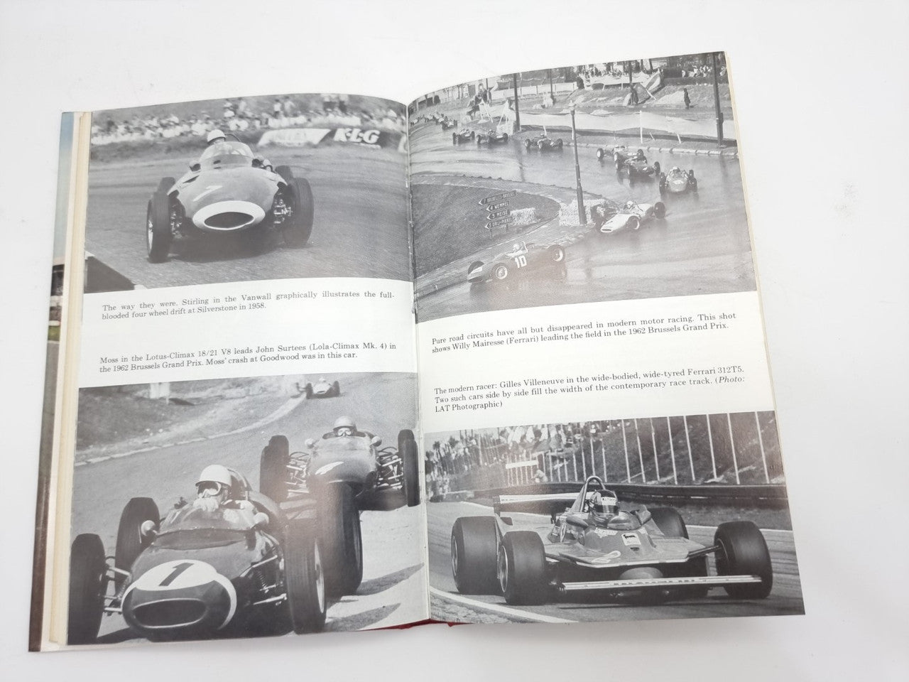 Open motorsport book spread with four black-and-white racing car images