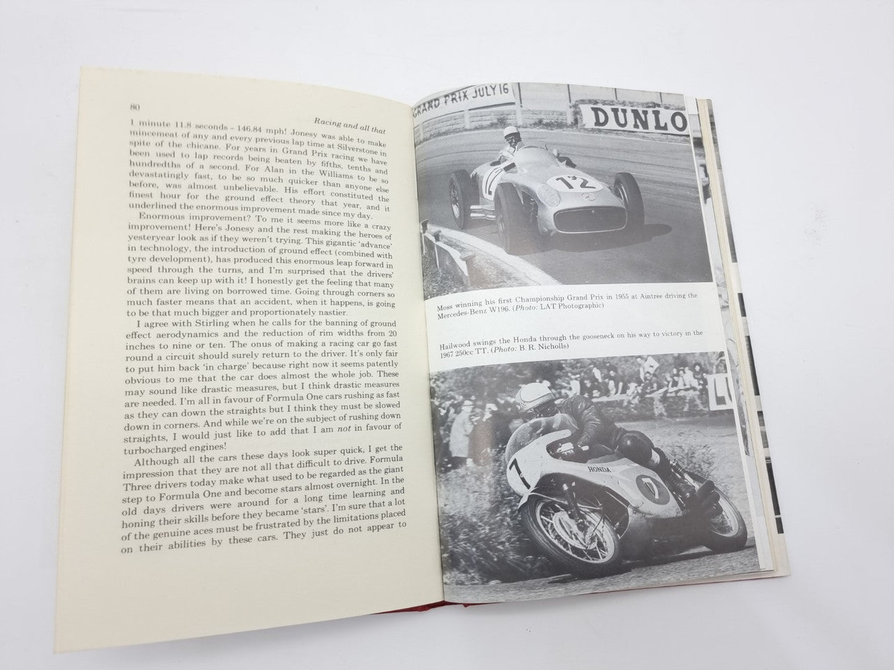 Open motorsport book spread with text page and two black-and-white car photos