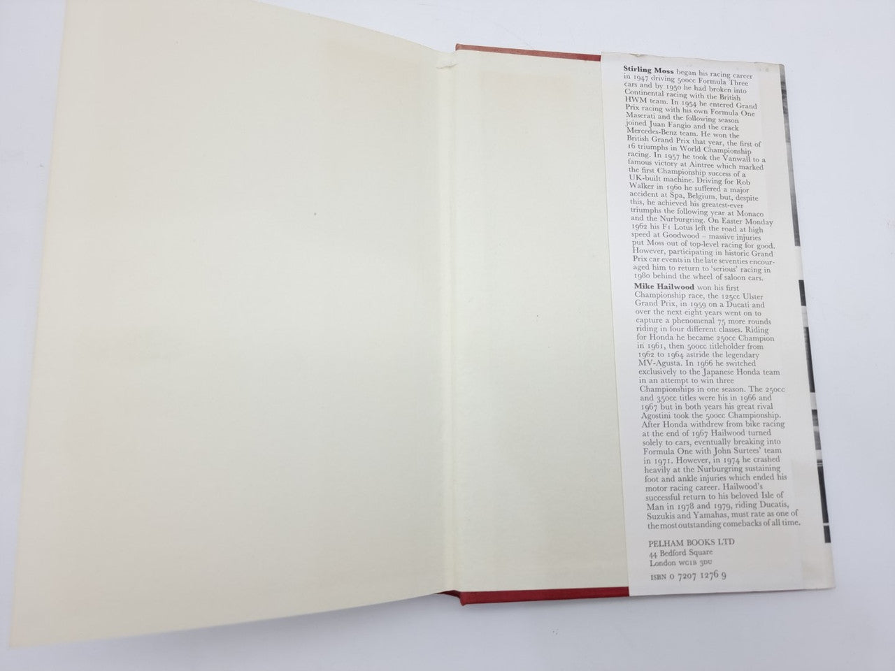 Open motorsport book with mostly blank left page and text on right page