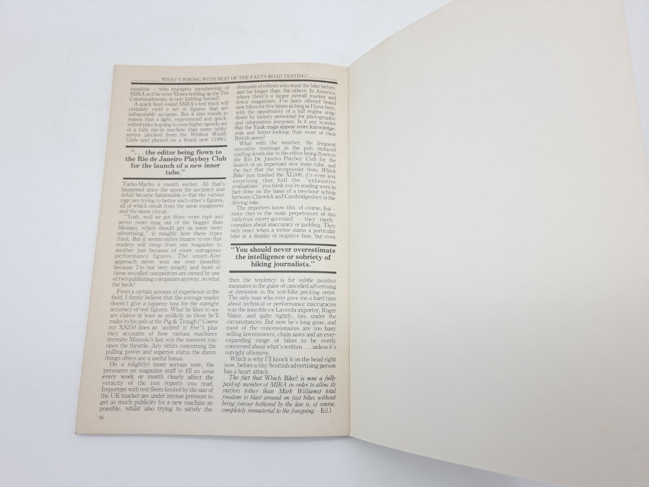 Vintage paperback book, open pages with dense article text on cream paper