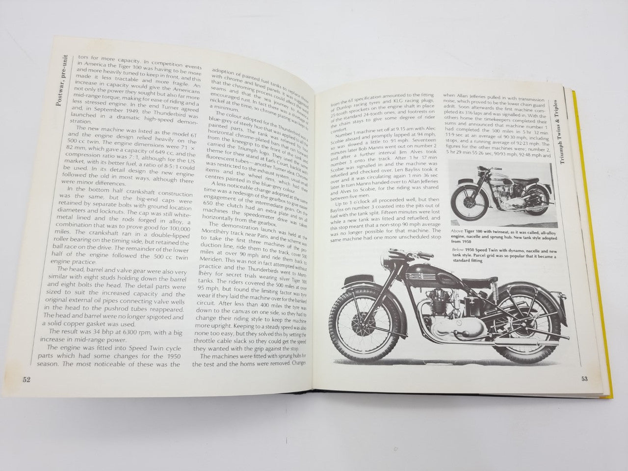 Open motorcycle repair manual with detailed motorcycle diagram and two-page text layout