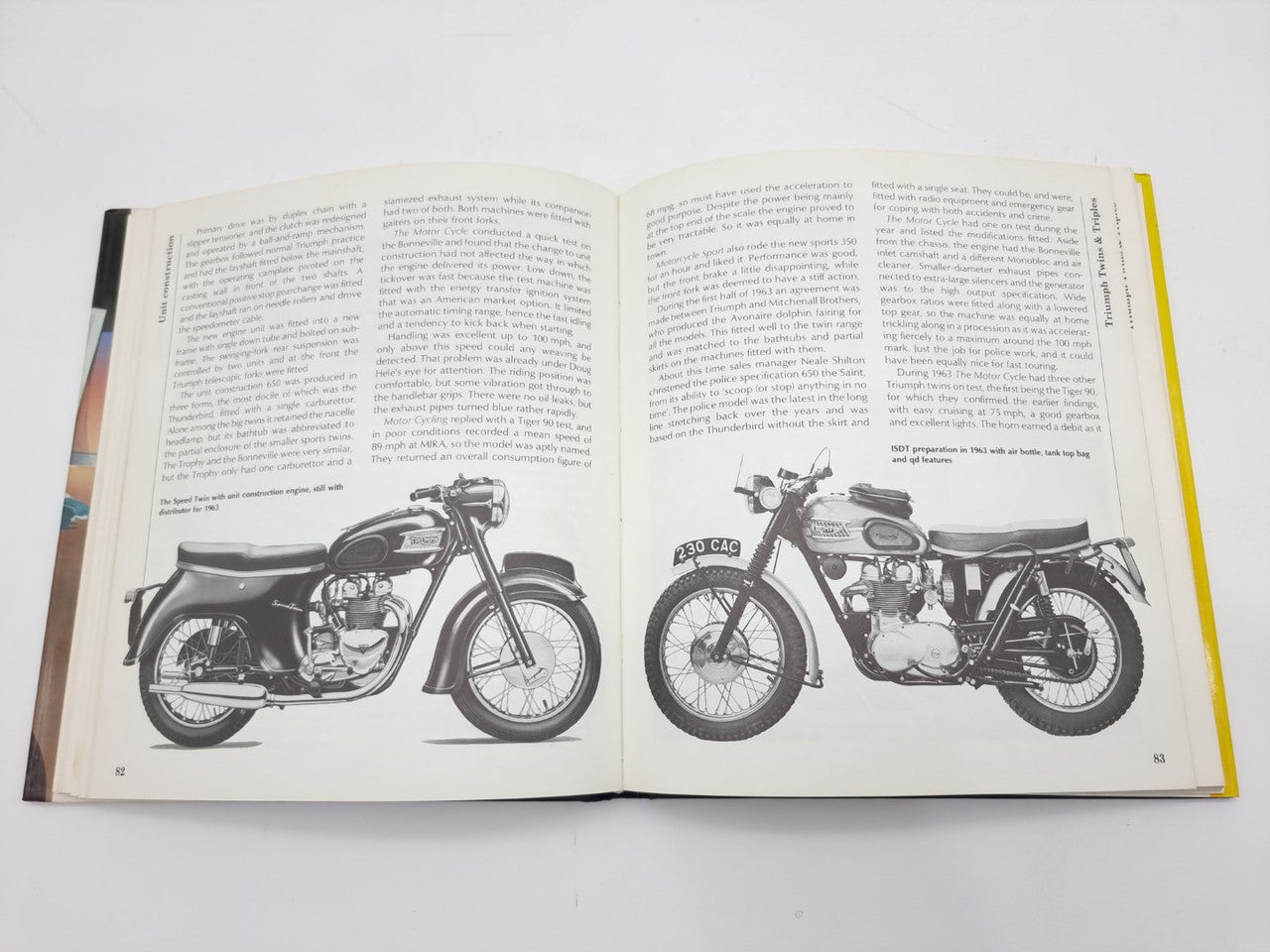 Open book spread with two black motorcycle images and printed descriptions