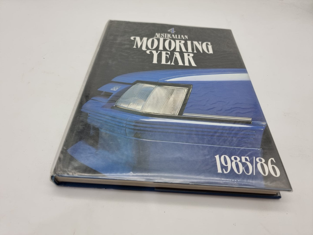 Motoring year book cover with blue car illustration and 1985/86 text