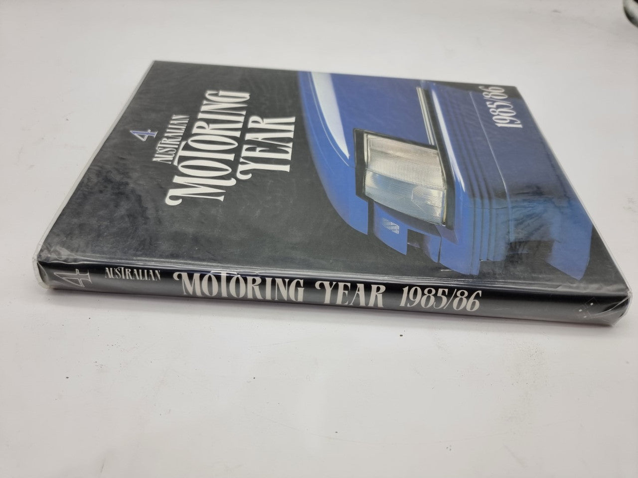 Motoring year book cover, angled view with 1985/86 and car graphic