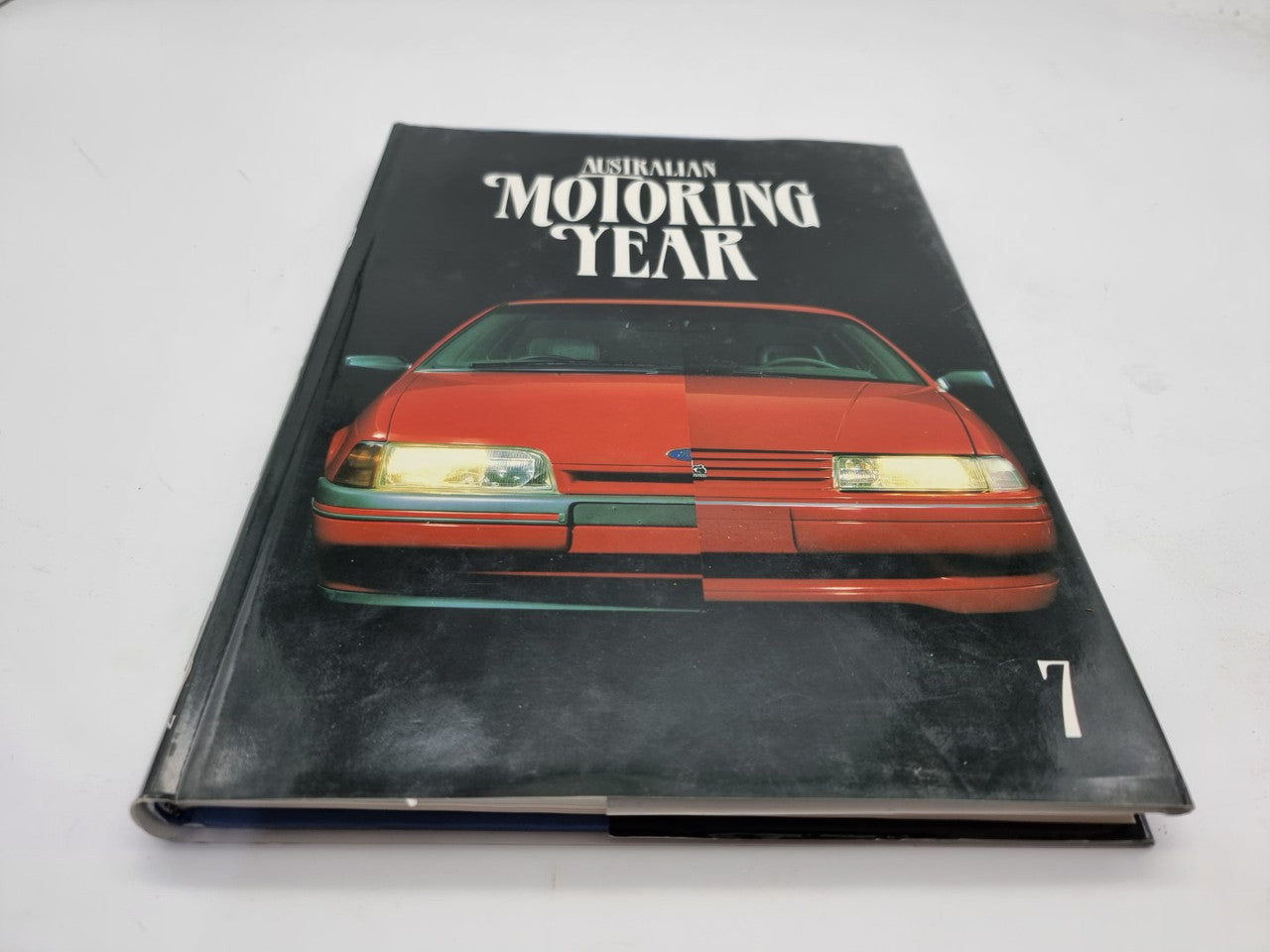 Motoring Year 7 book, black cover with red car illustration and title text