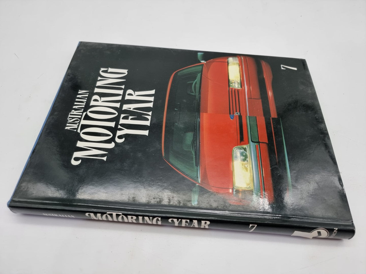Motoring Year 7 book cover, black with red car art and large title text