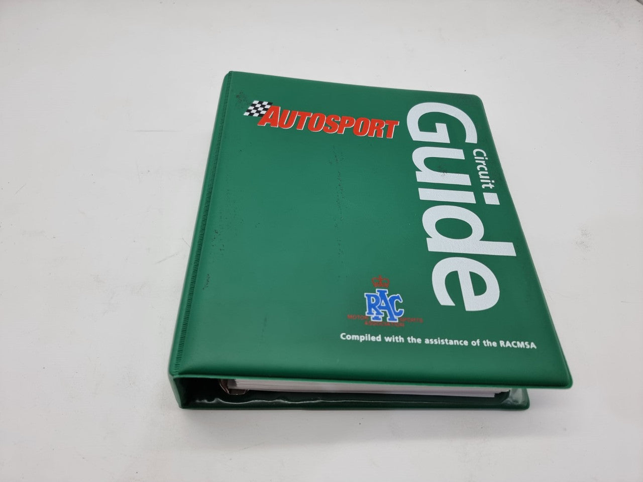 Green circuit guide book with red and white title text on the cover