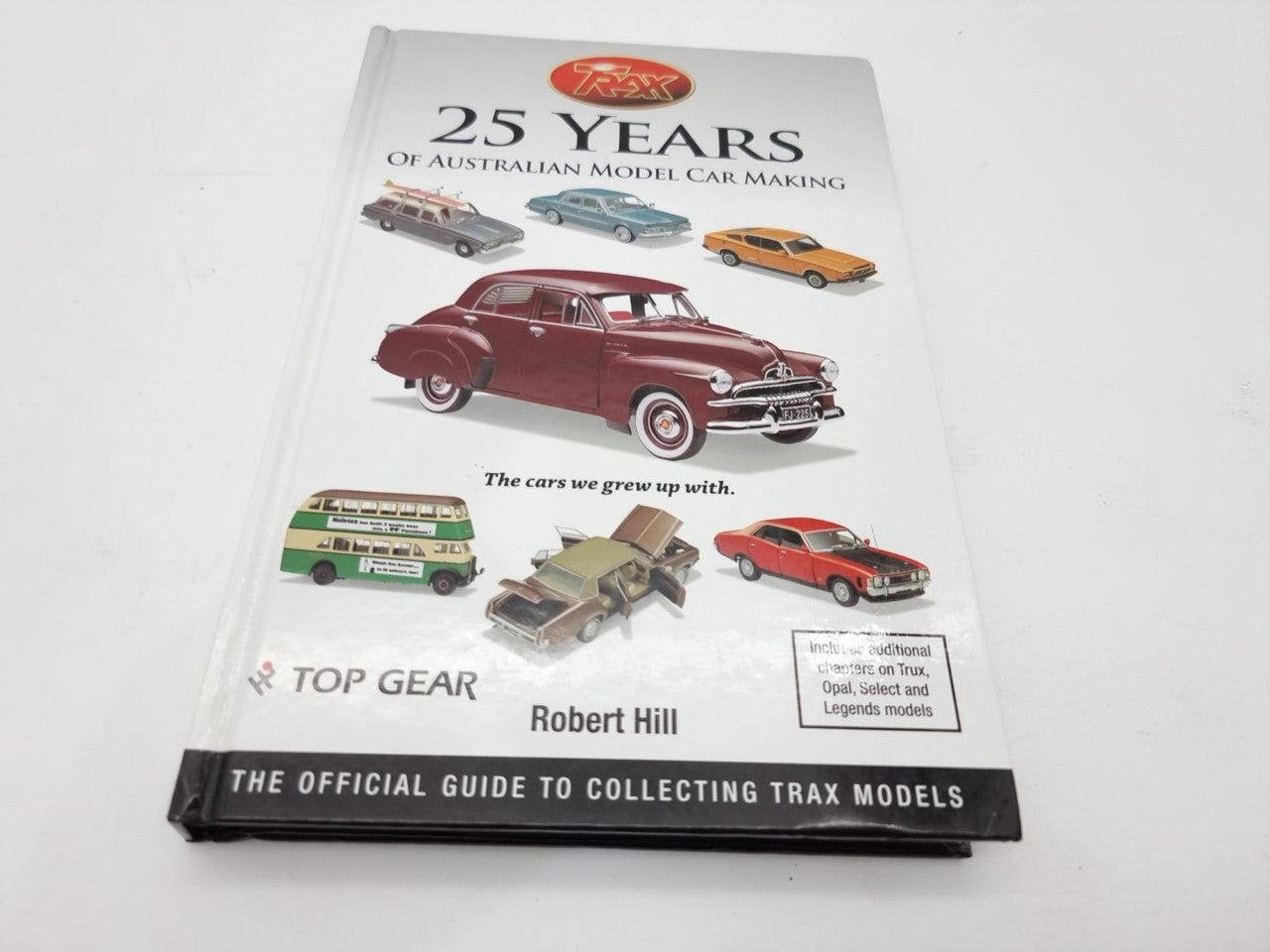 Model car making guide book with “25 Years” cover art and classic red car illustration