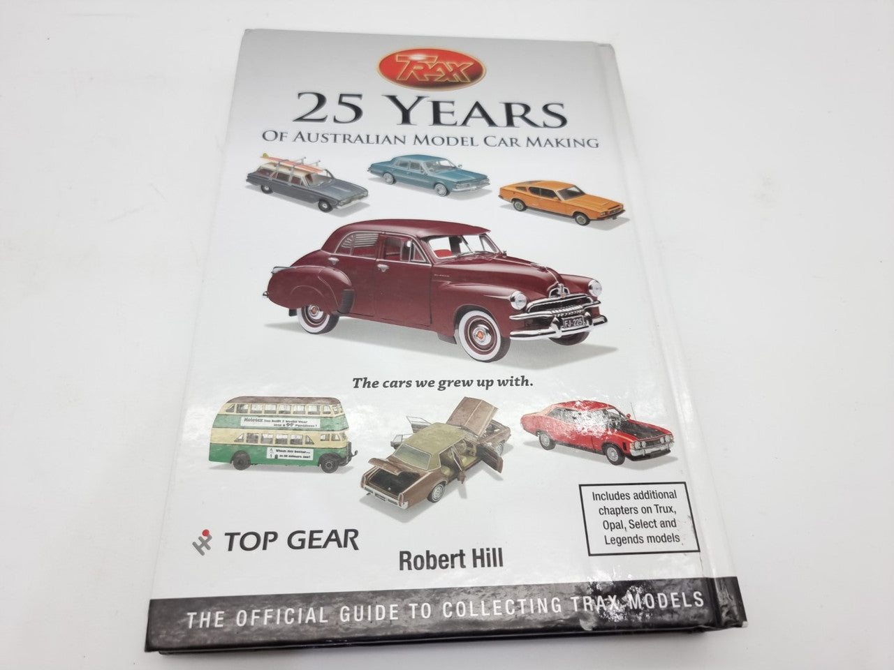 Model car making guide book front cover with “25 Years” title and classic car lineup