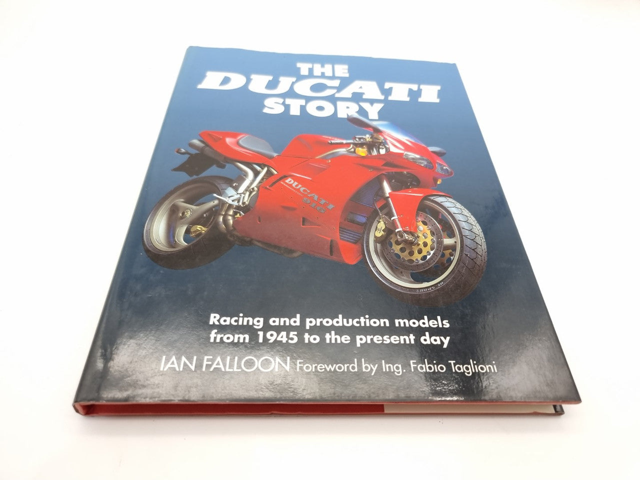 The Ducati Story book with red sport motorcycle on blue cover