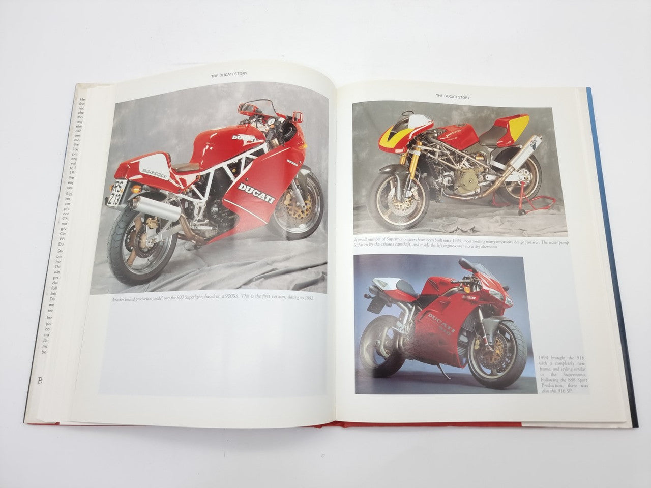 Motorcycle photo book, open pages with red sport bike images and details