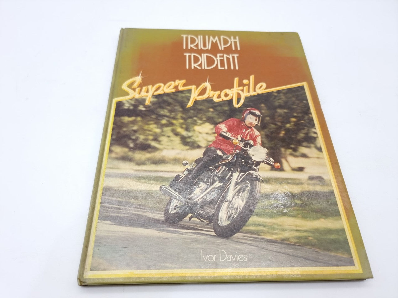Triumph Trident Super Profile motorcycle manual cover with rider on bike, front view.