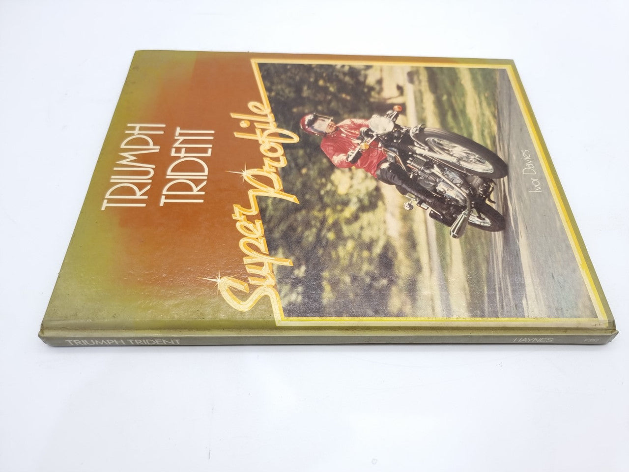 Triumph Trident Super Profile motorcycle manual cover with stylized bike riding scene.