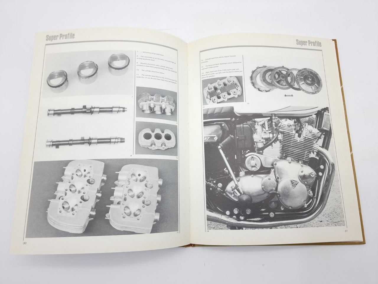 Triumph Trident motorcycle manual open with engine parts diagrams and workshop photos.