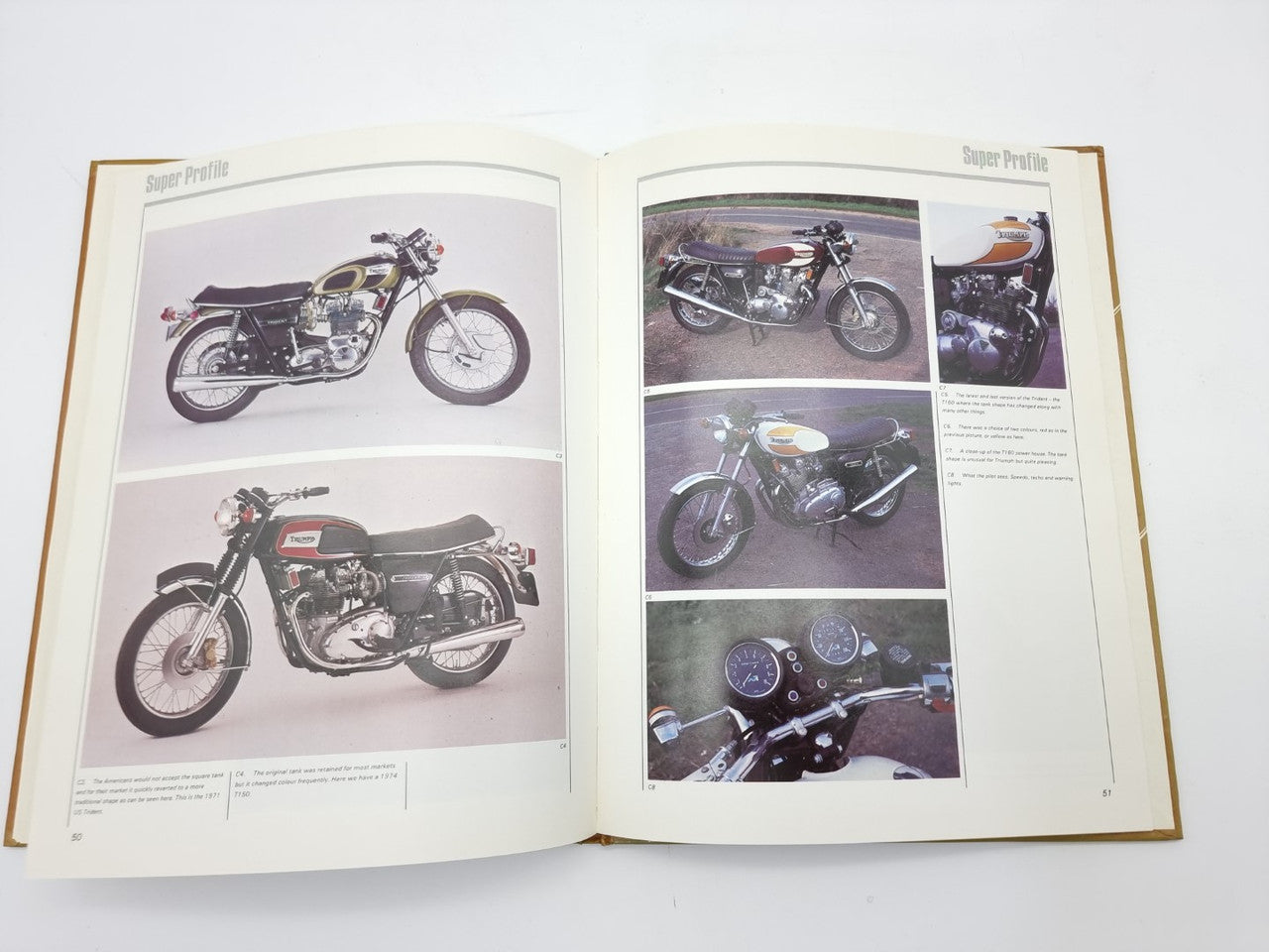 Open motorcycle manual showing full bike photos and instrument panel closeup