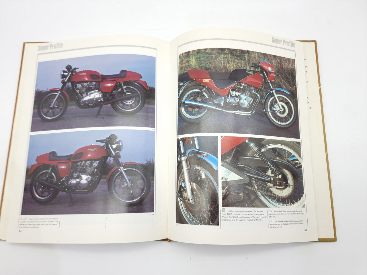 Open motorcycle manual featuring red motorcycle photos and engine closeups