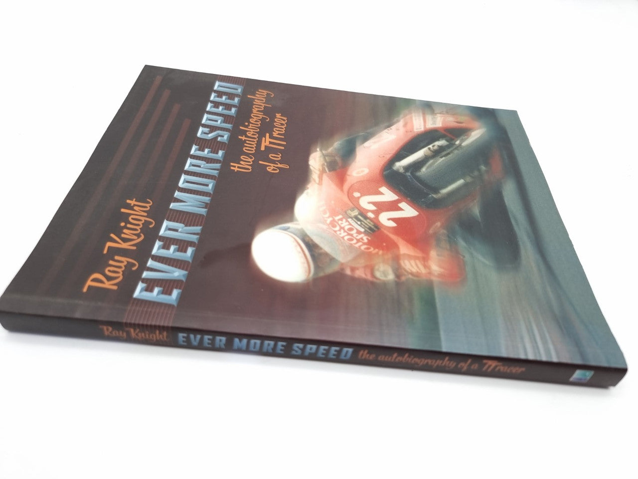 Paperback cover with a red-and-blue racing motorcycle and bold title on dark background