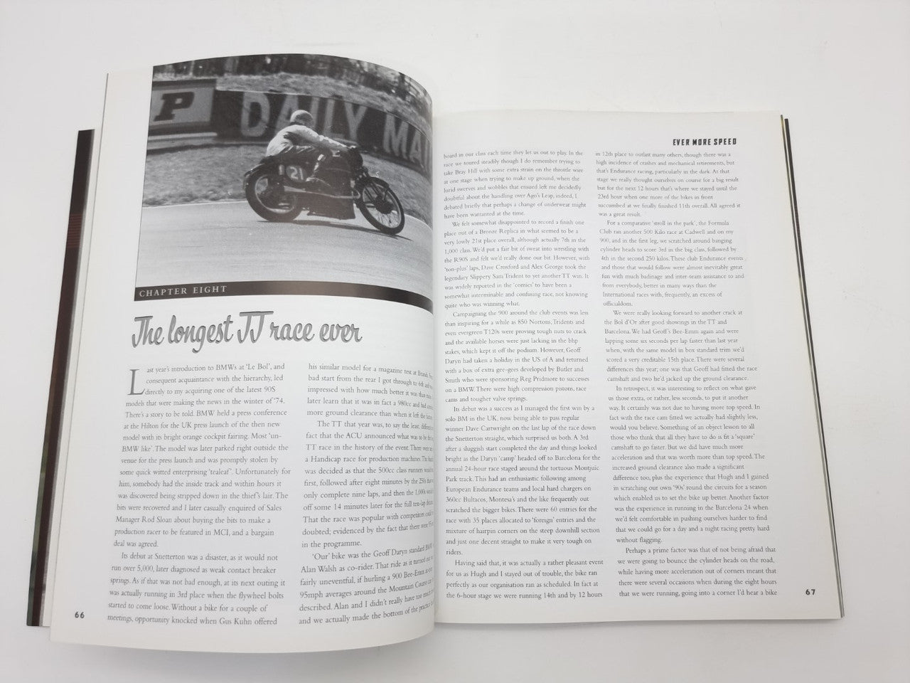 Open book page with black-and-white motorcycle photo and dense text columns
