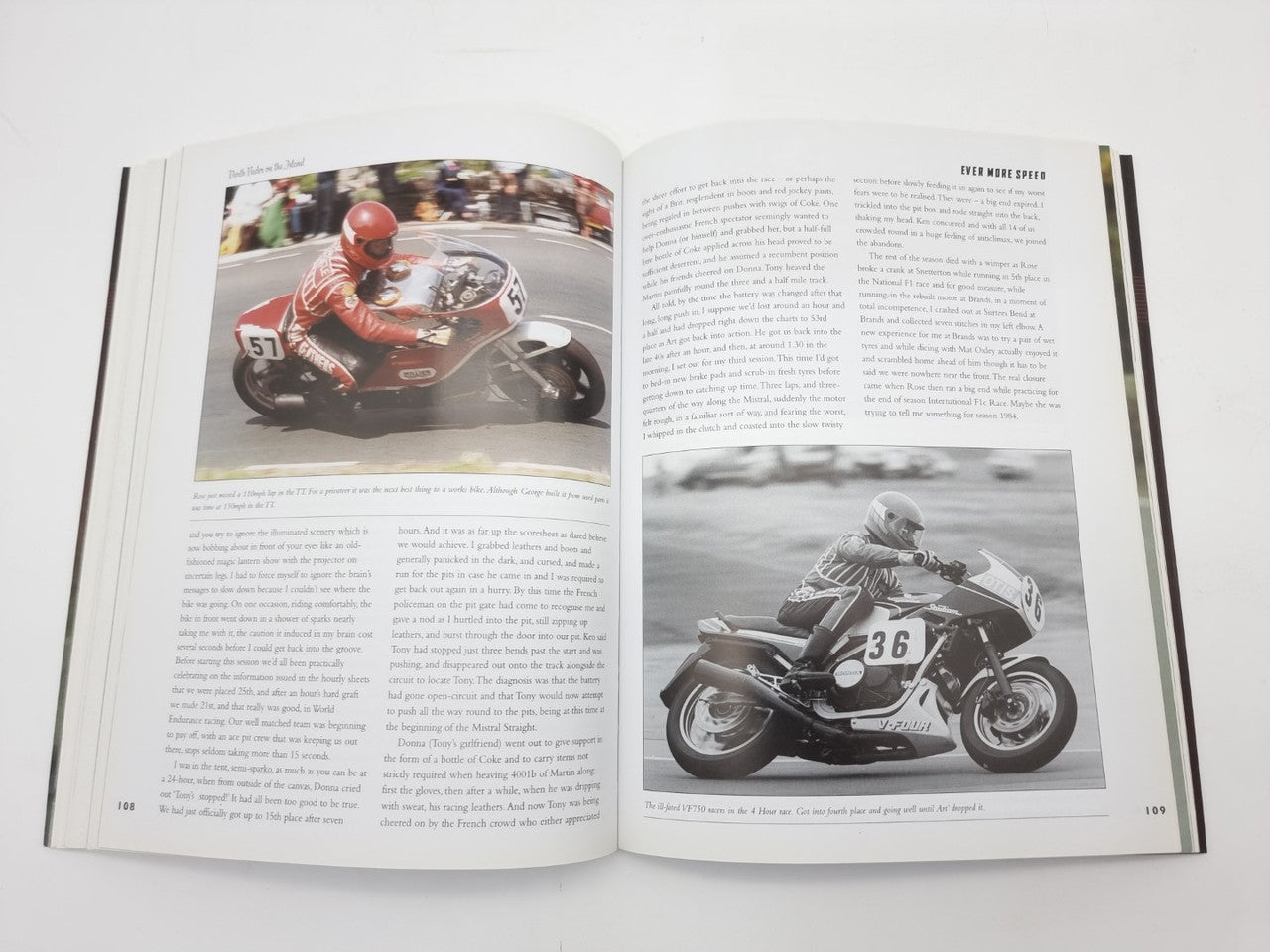 Open autobiography book spread with color motorcycle images and text pages