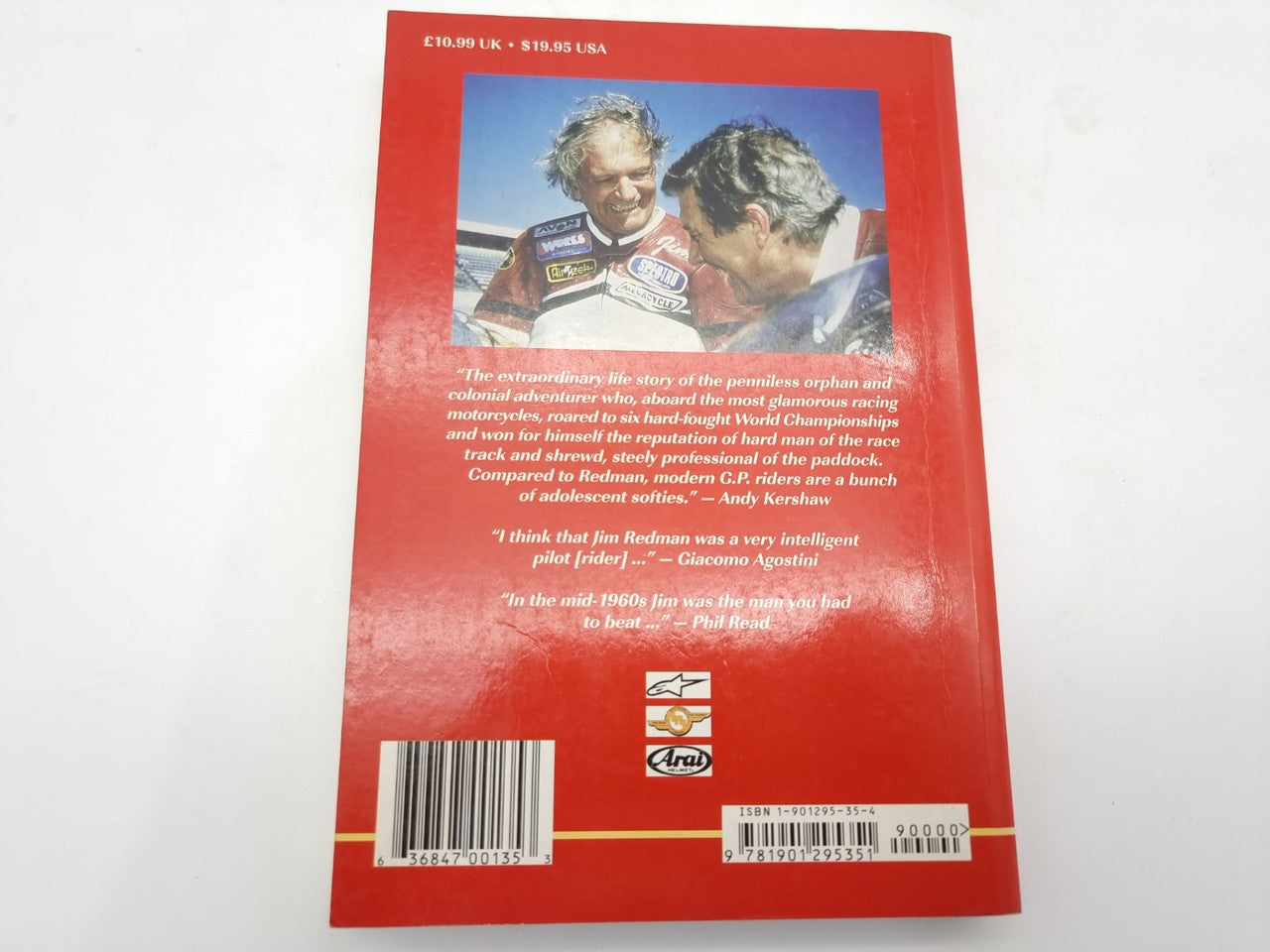 Red back cover of motorcycle autobiography book with author photo, barcode, and publisher logo