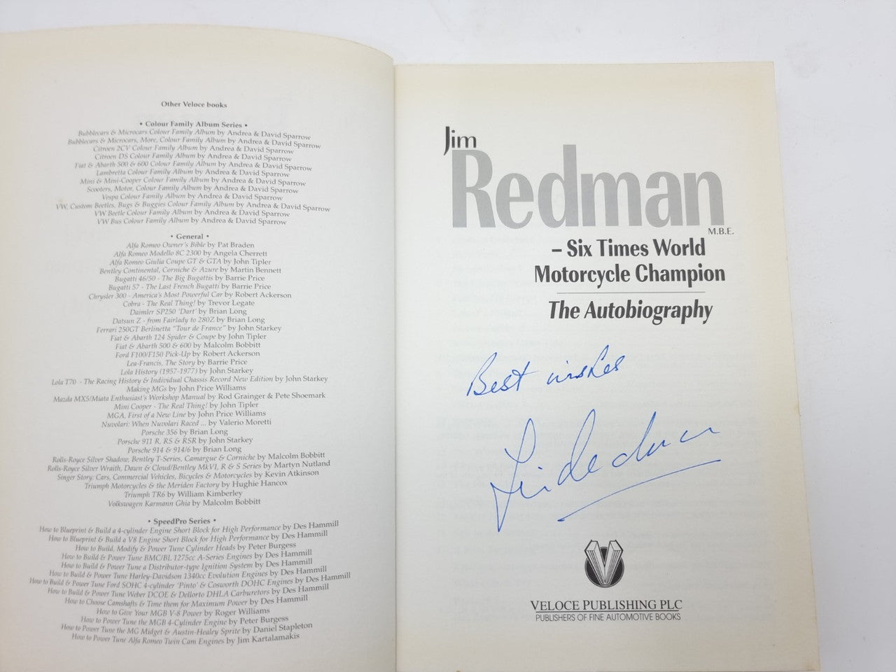Open book with “Jim Redman” title page and handwritten signature across the right page