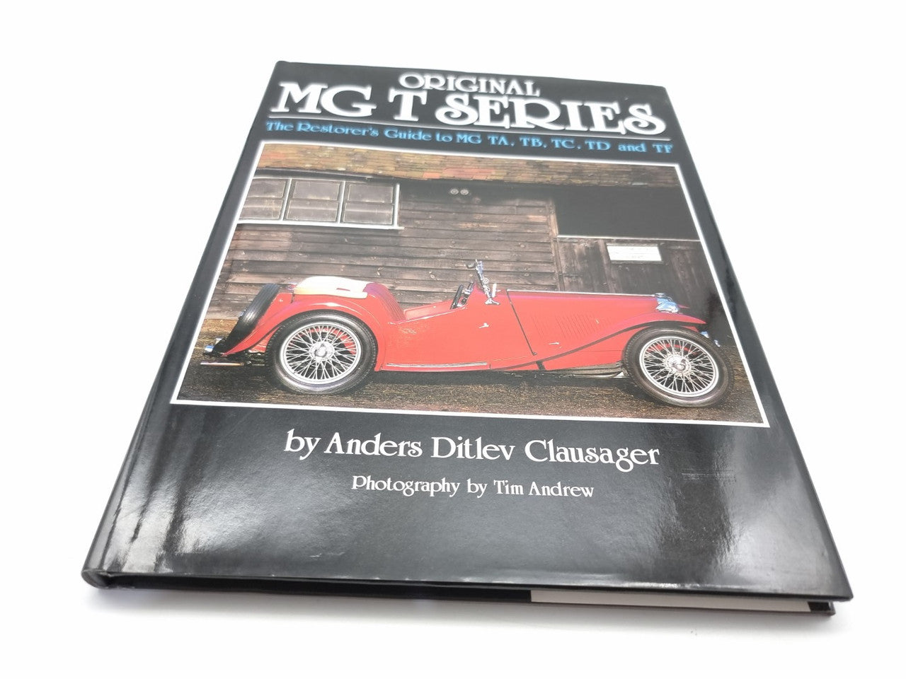 Automotive restoration guide book cover with red classic MG car side photo and author name