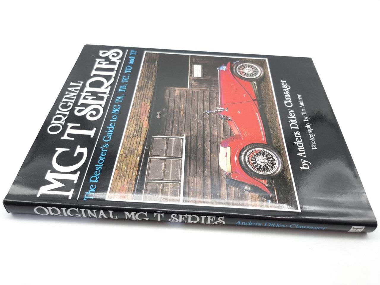 Automotive restoration guide book cover with large title text and red car photo