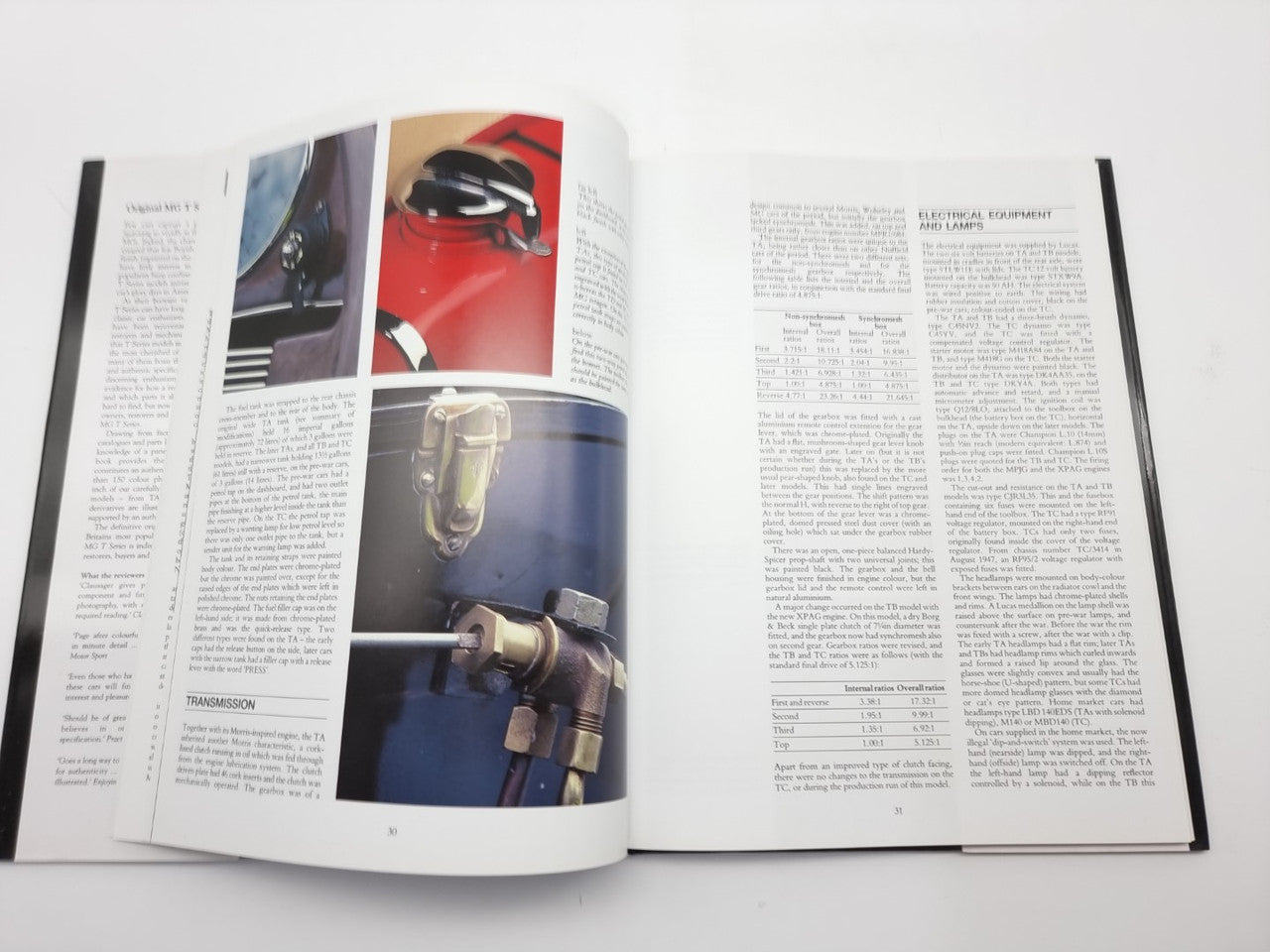 Open guide book with close-up car diagrams, photos, and columns of printed text