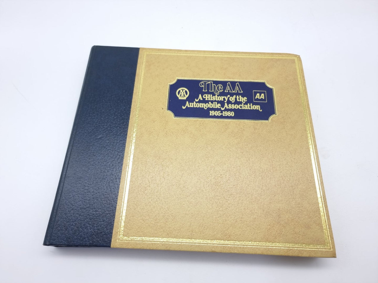 AA automobile association history book, dark blue and gold hardcover with logo