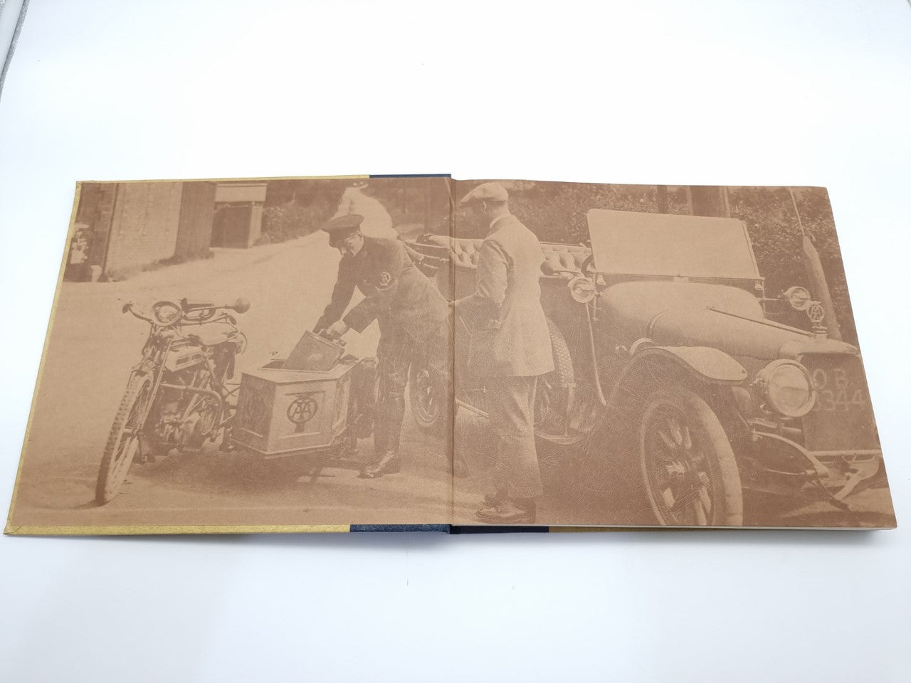 AA automobile association history book, open spread with vintage vehicle photos