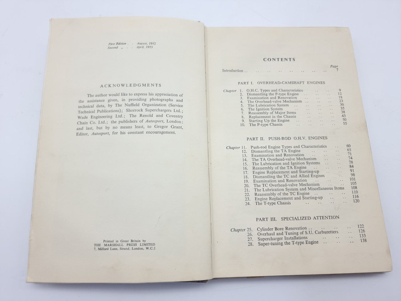 Open vintage car maintenance manual with contents list and numbered chapters